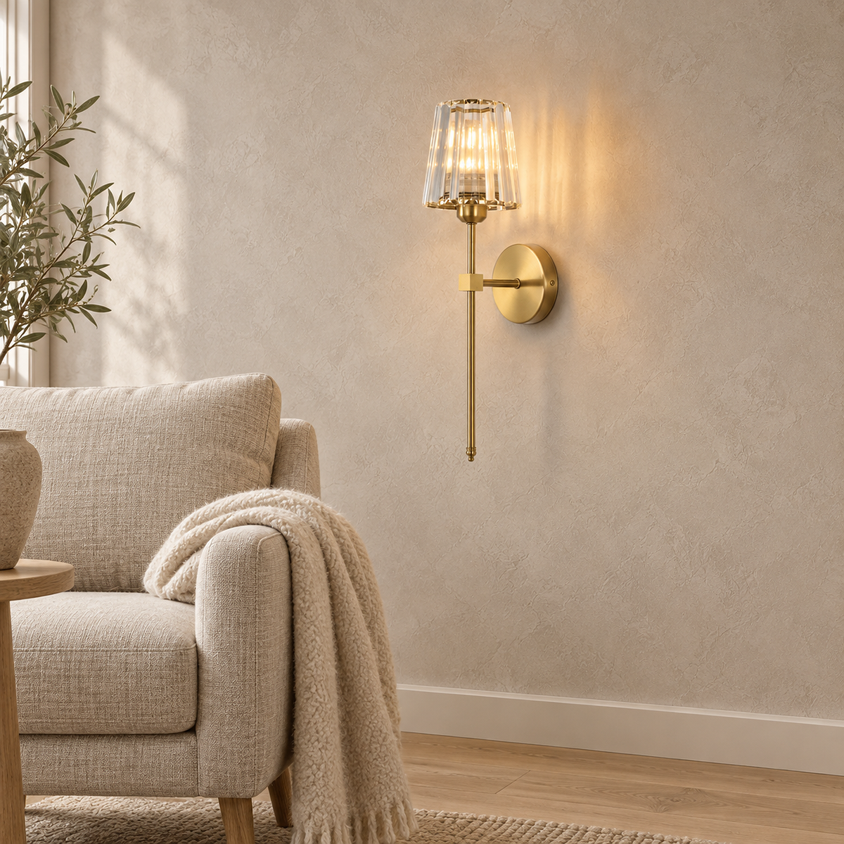 Tavirelo gold wireless wall light lit beside an oatmeal reading chair in an alcove #color_gold