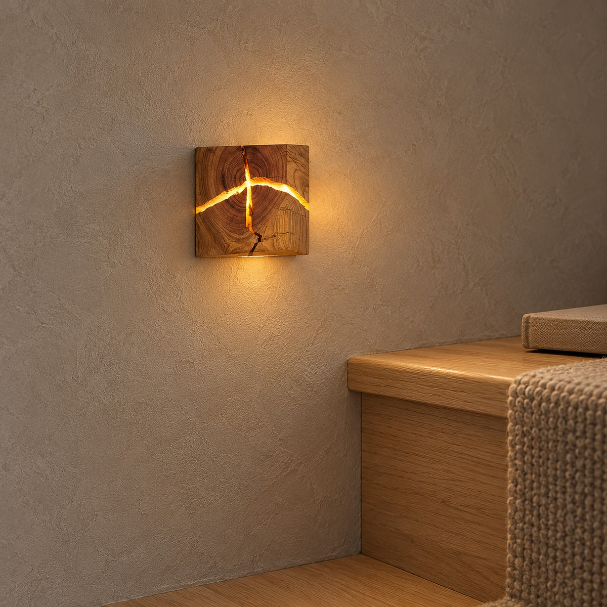 Temalio natural brown wood hardwired wall light glowing on a beige wall beside wooden stairs.