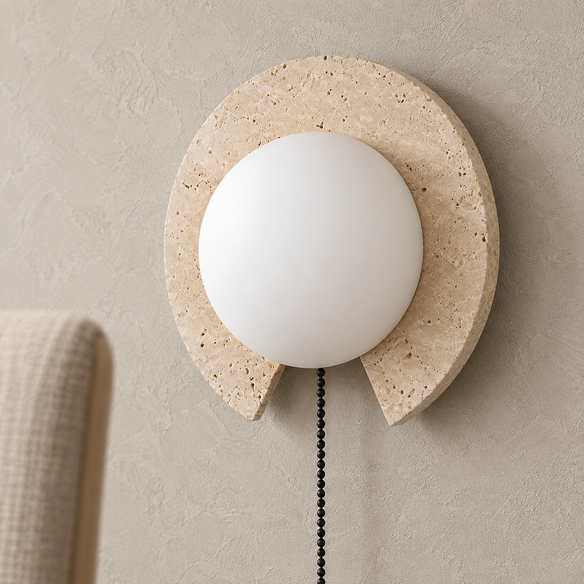 Teselma beige and white travertine wall lamp showing stone pores and the white globe