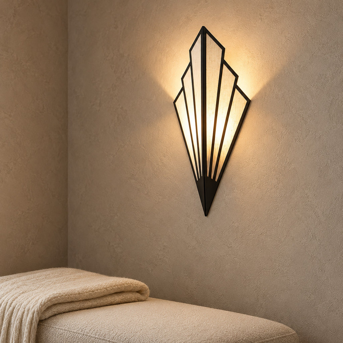 Ticorena black wall light angled in an entry vestibule to reveal its dimensional panels