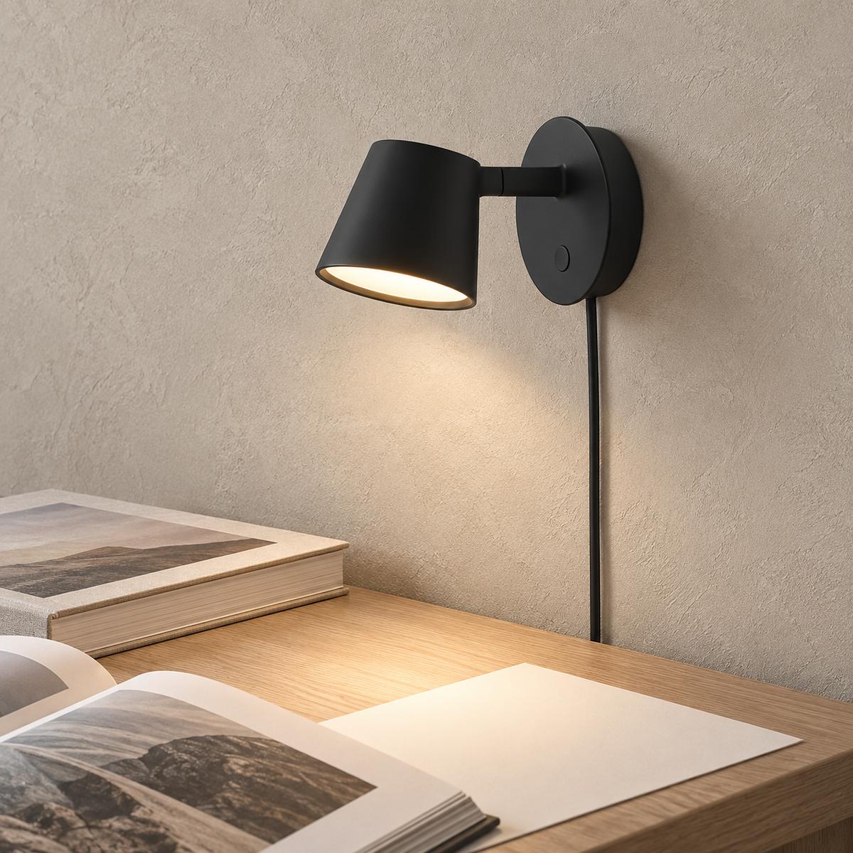 Tisello black LED wall sconce lighting a clear craft studio desk in daylight