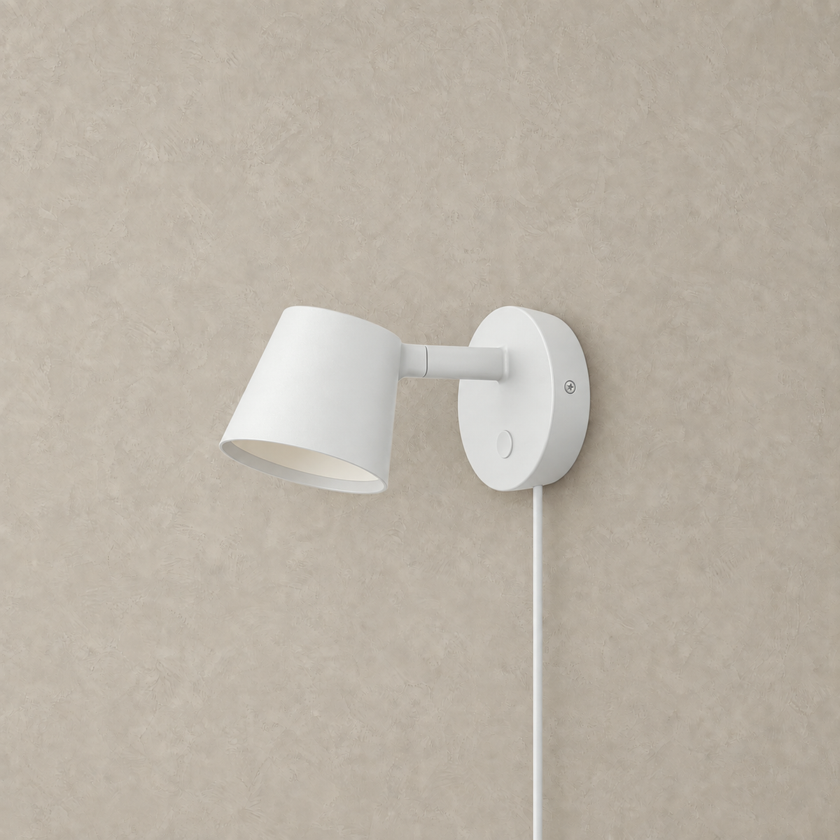 Tisello white adjustable wall sconce with its tapered shade unlit on a plain backdrop #color_white