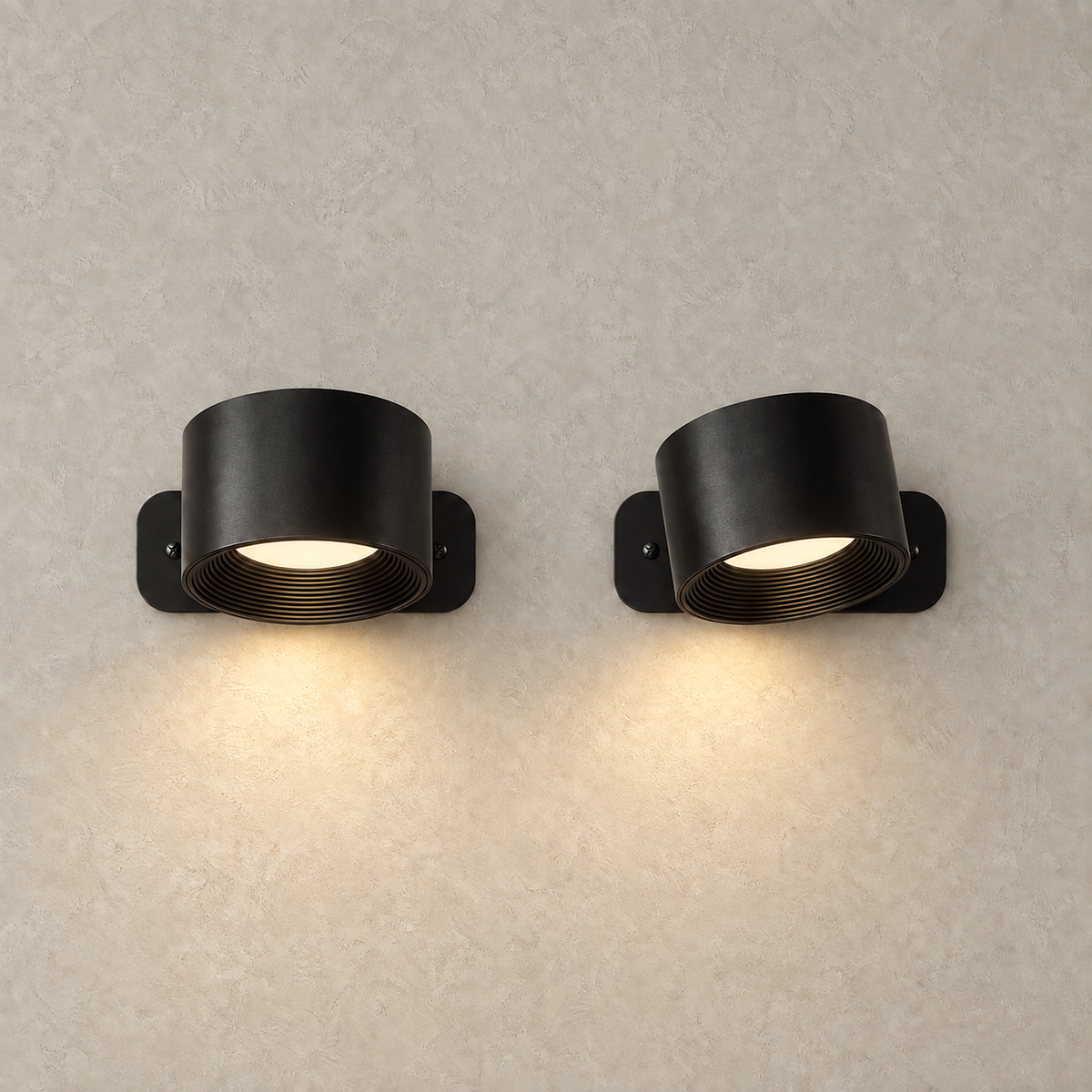 Tomelira black cordless wall lamp switched on casting a warm downward wall wash