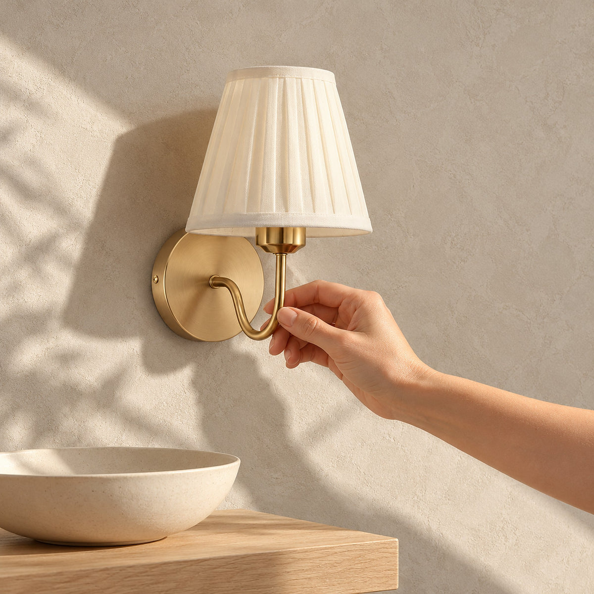 Tomirel gold battery operated wall sconce, unlit, on a dining room wall in direct daylight