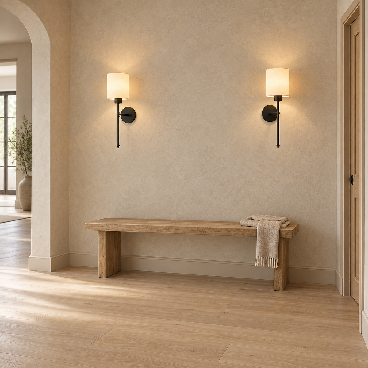 Toselio black cordless wall lamp pair glowing above a hallway bench