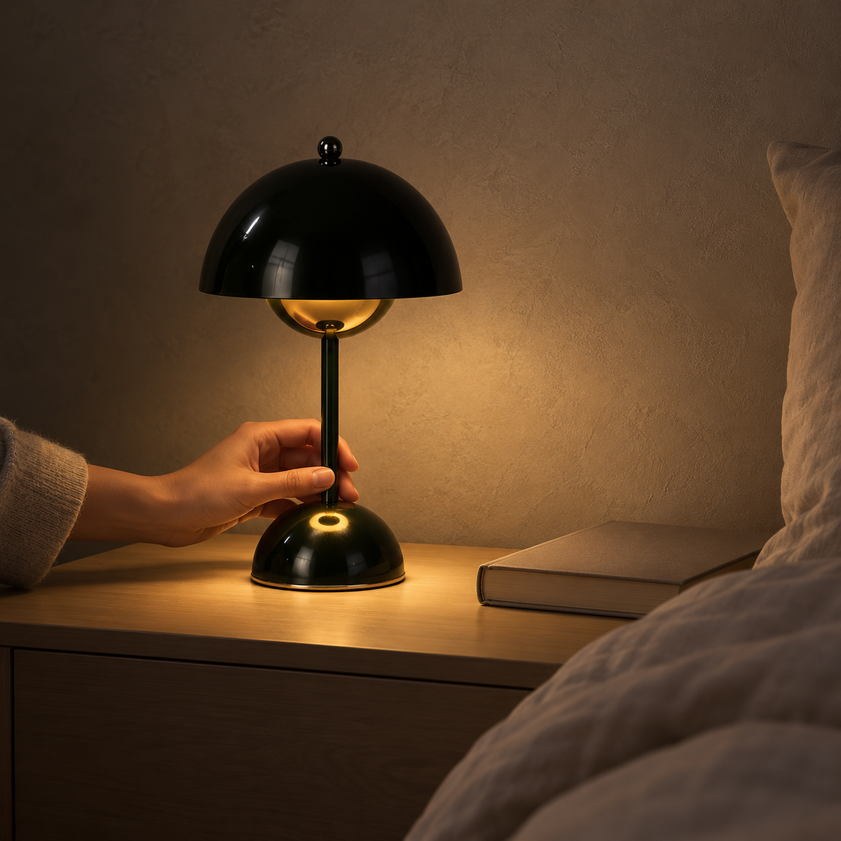 Varimel black rechargeable table lamp giving a low warm evening glow in an upstairs bedroom