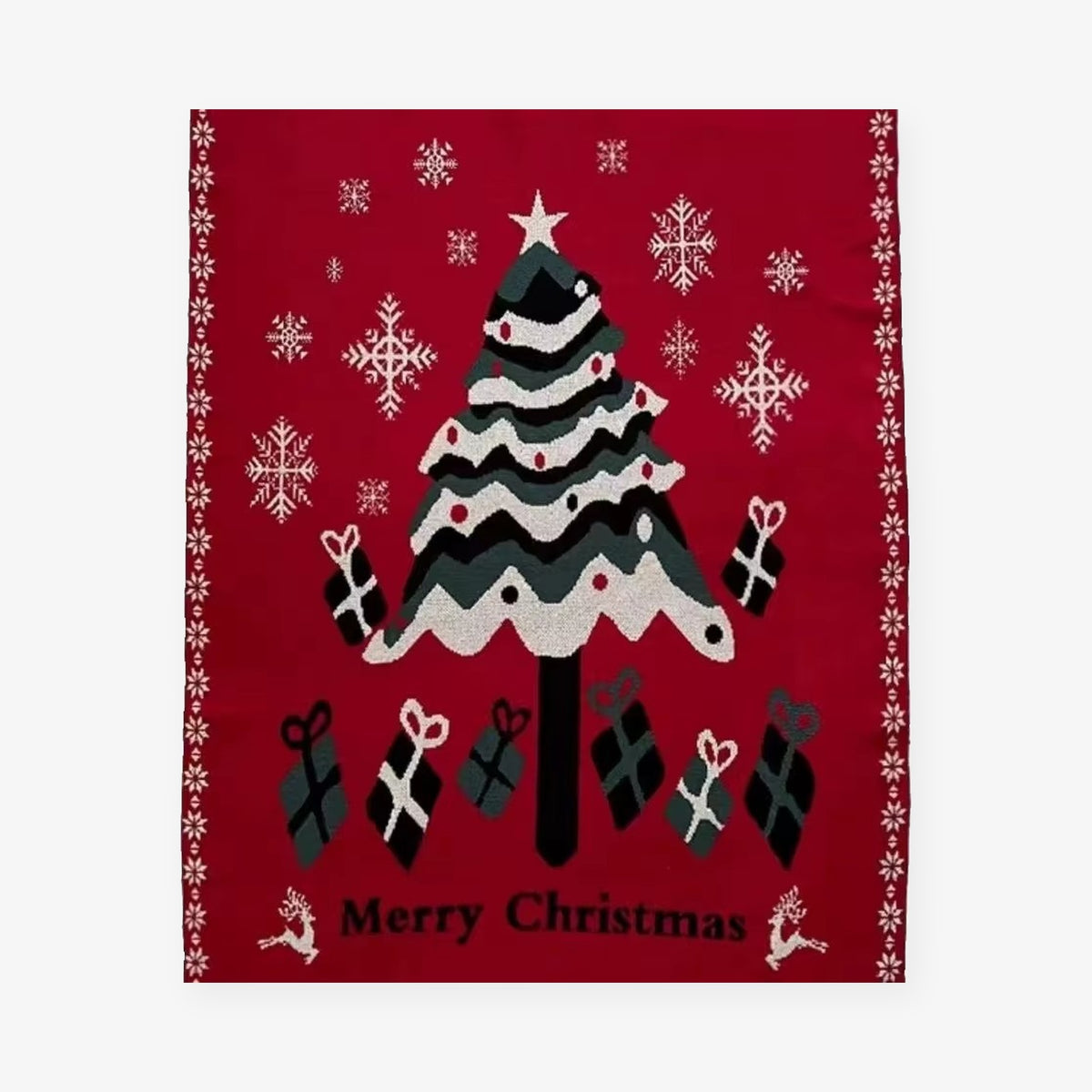 Velimoro christmas knit throw blanket shown fully laid flat, with a tree, gifts and snowflakes on red.