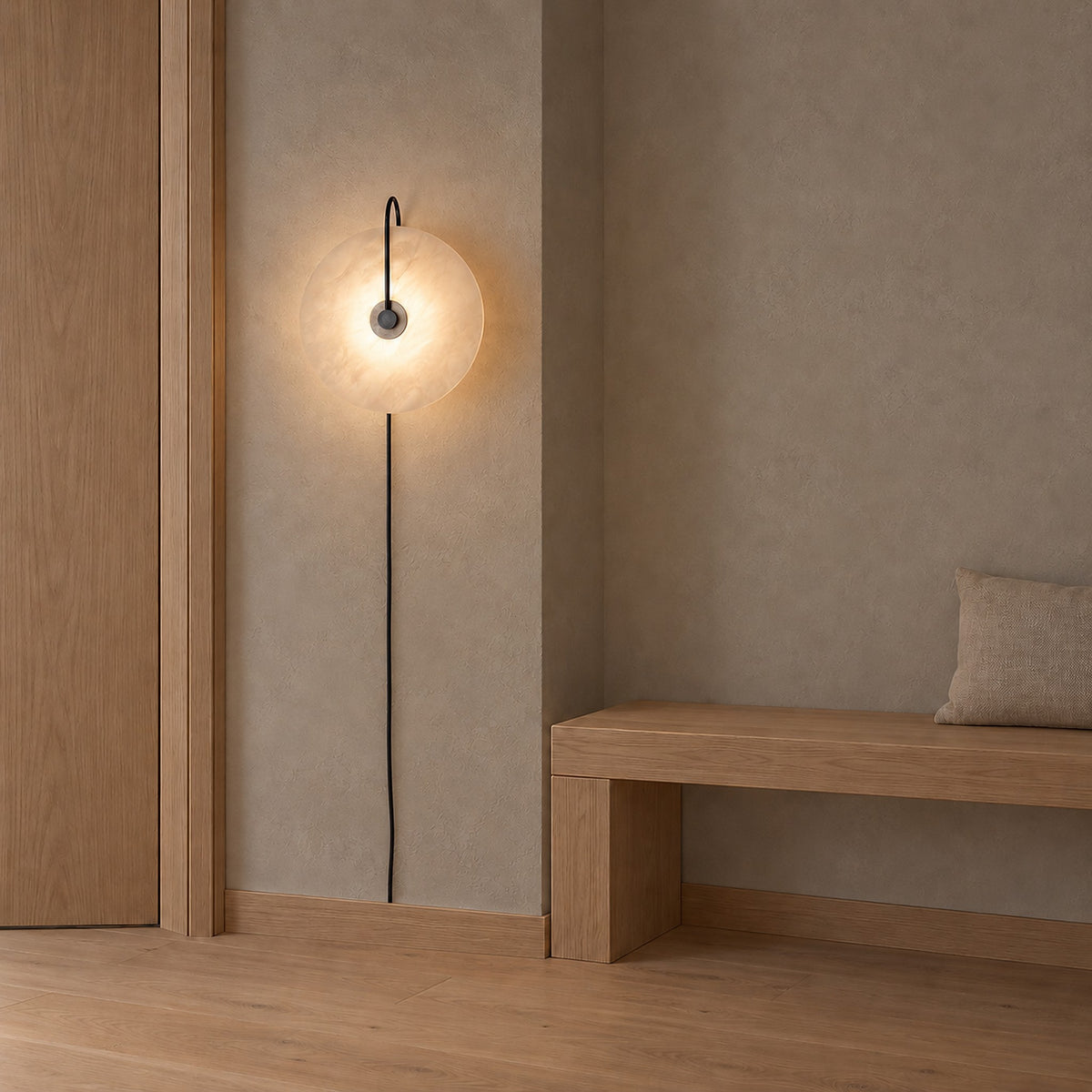 Velirsa black plug in wall sconce on a narrow plaster wall beside a doorframe