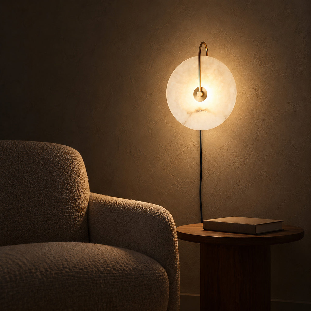 Velirsa gold LED wall sconce casting a soft evening glow across a reading corner wall #color_gold