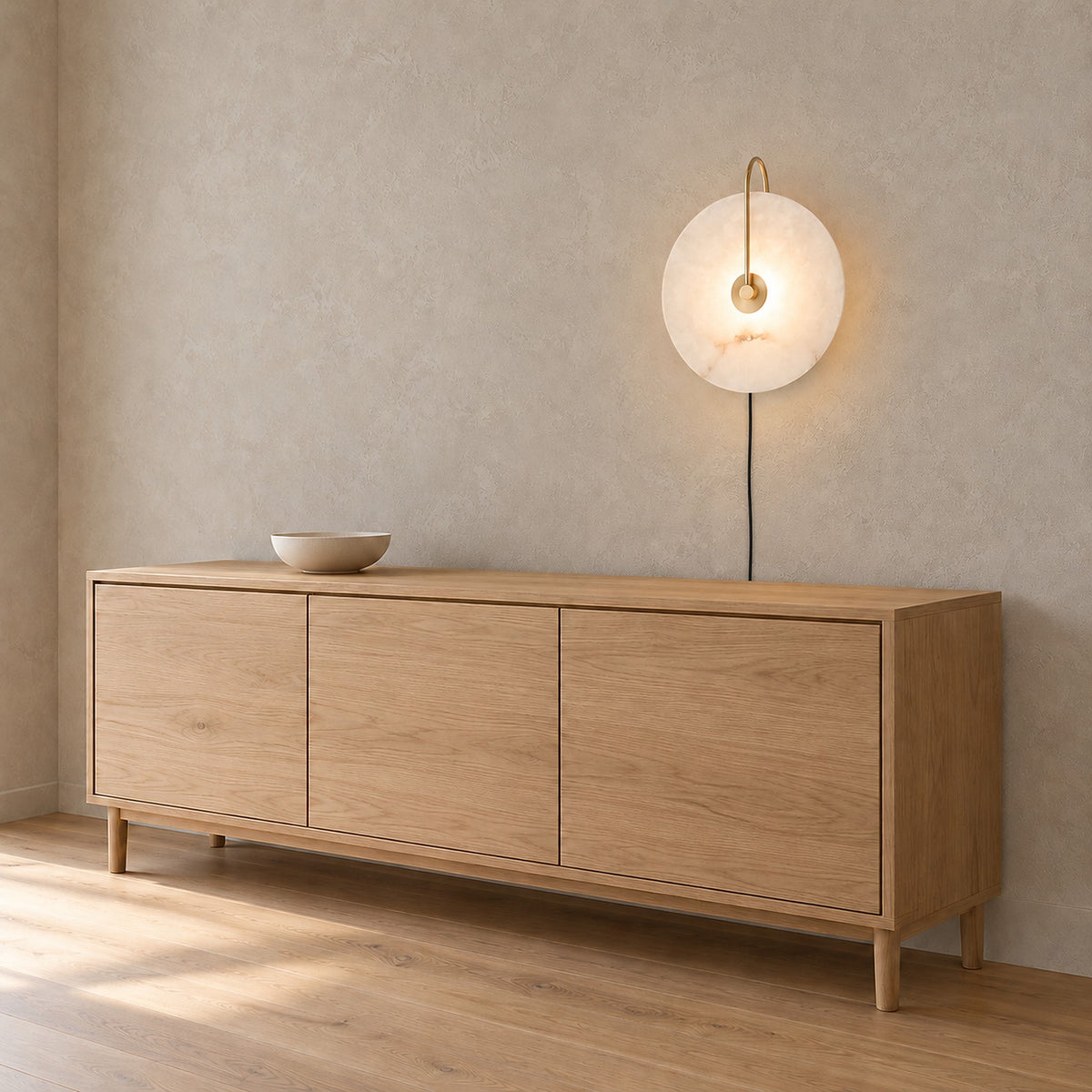 Velirsa gold plug in wall lamp glowing above the dining room furniture in daylight #color_gold