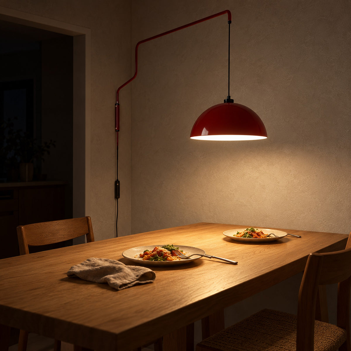 Velisano dark red wall sconce lighting a quiet dinner in an eat in kitchen corner at night