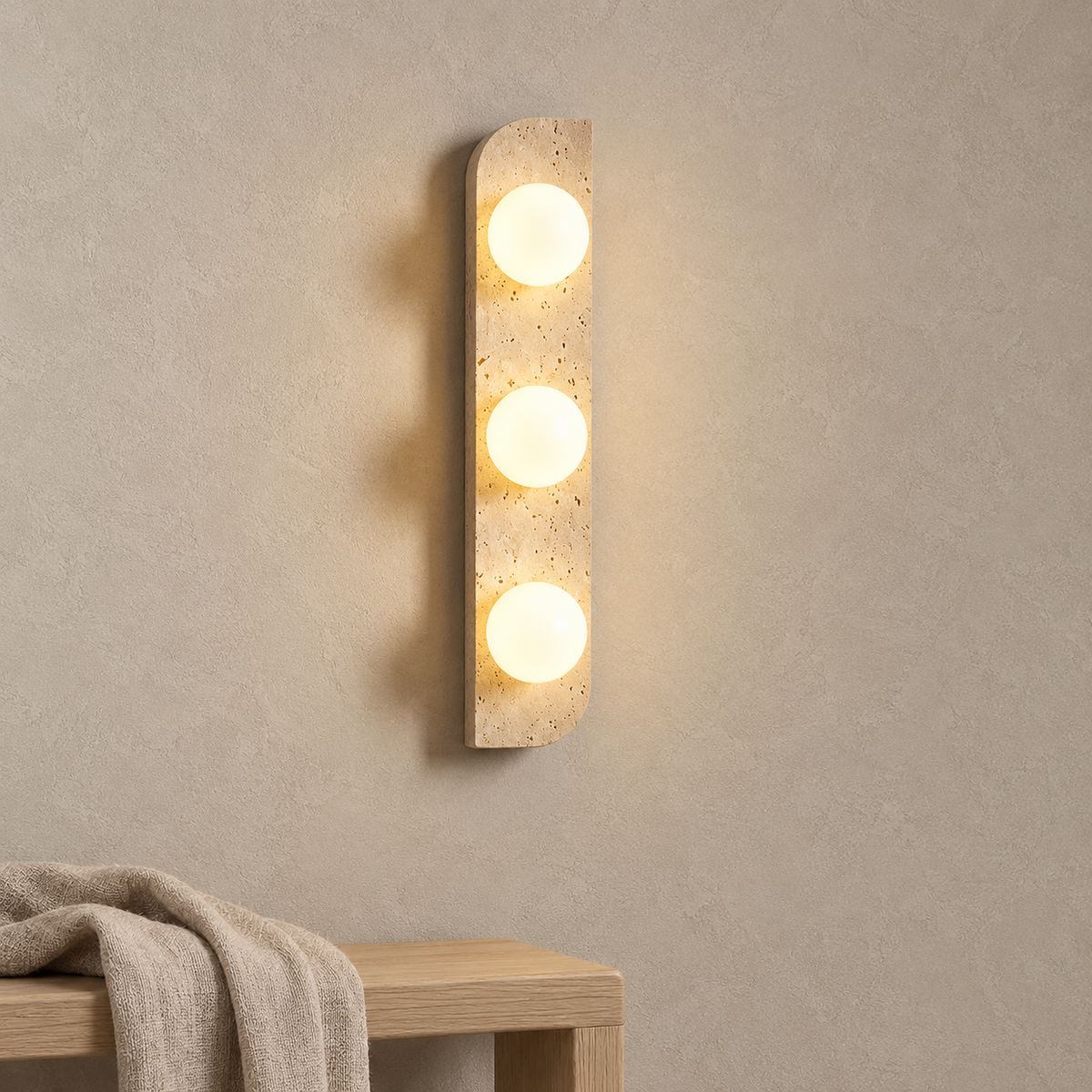 Vemarilo yellow travertine and white plug in wall lamp glowing above an entry bench