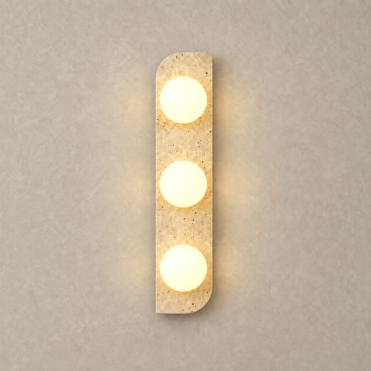 Vemarilo yellow travertine and white plug in wall sconce lit against warm plaster
