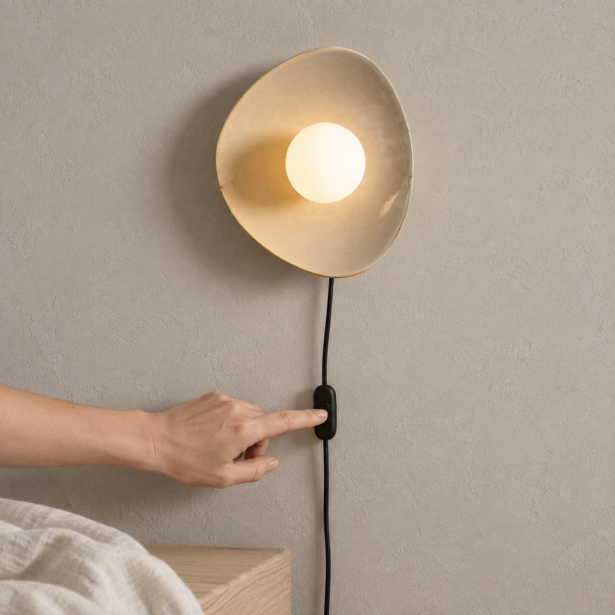 Venalti taupe bedside lamp lit in the alcove showing the inline on off switch on its cord