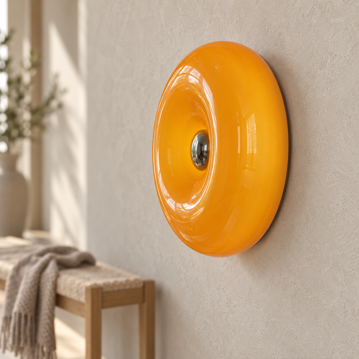 Vilomer orange wall lamp in close detail, showing the glass center and curved rim