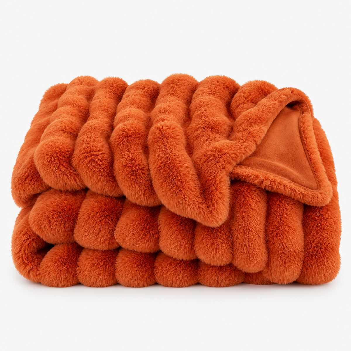 Vimarel burned orange faux fur throw blanket loosely folded with its silky micromink fleece reverse showing