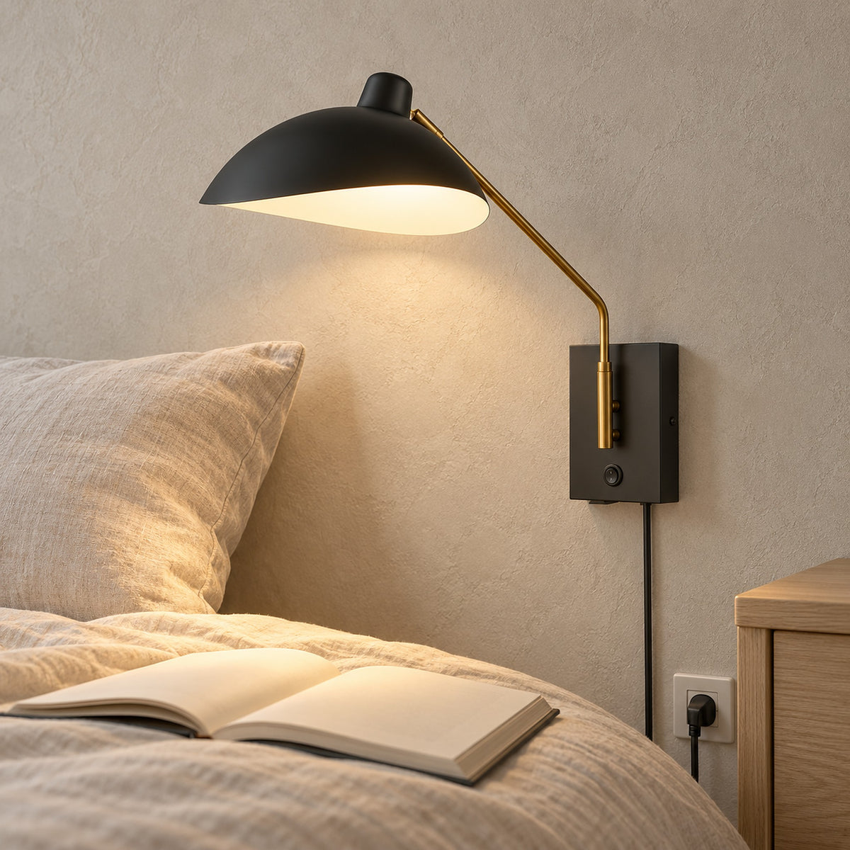 Vimolen black bedside wall light glowing over an open book in a guest sleeping alcove by day