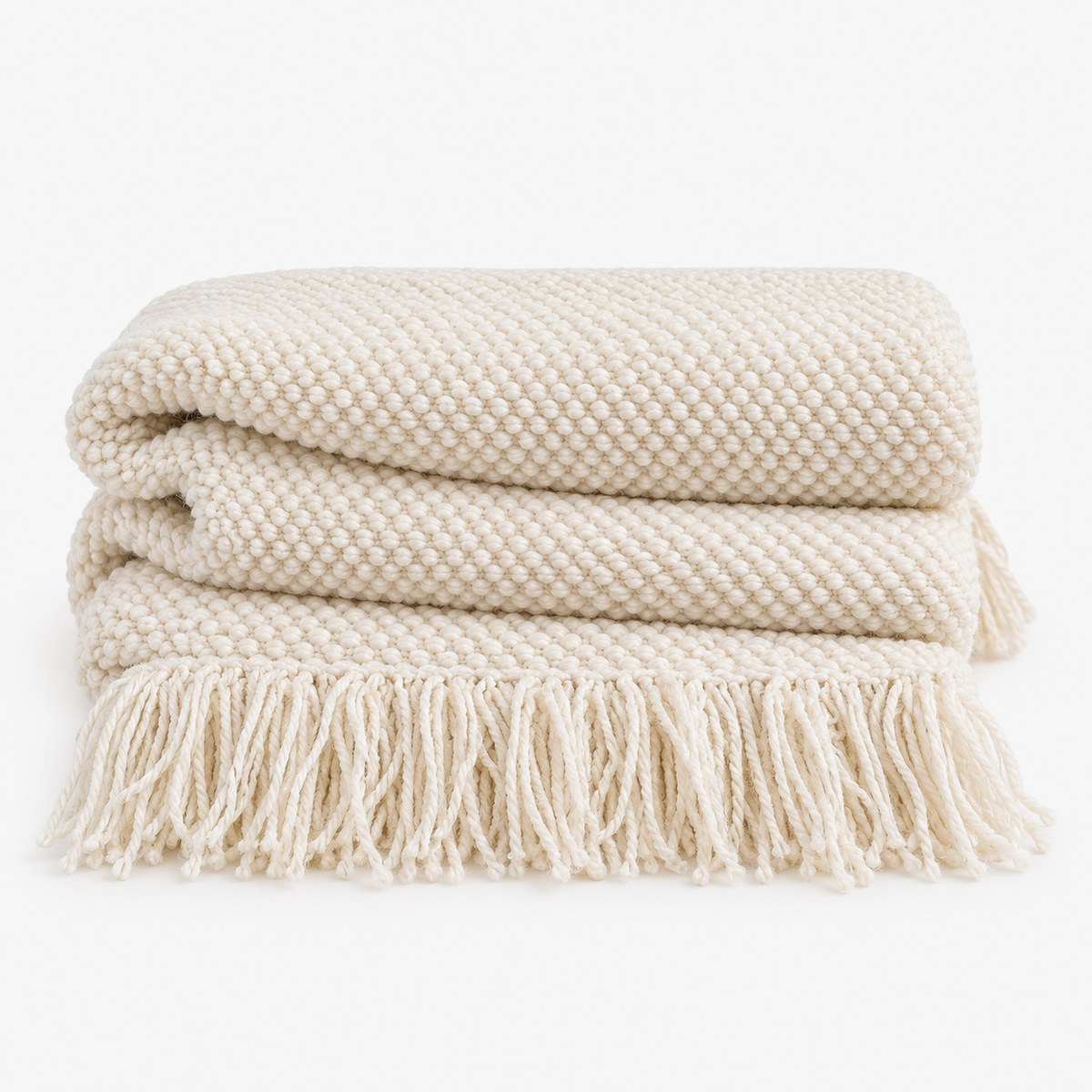 Volisen white knit throw blanket loosely folded with tassel fringe at the ends