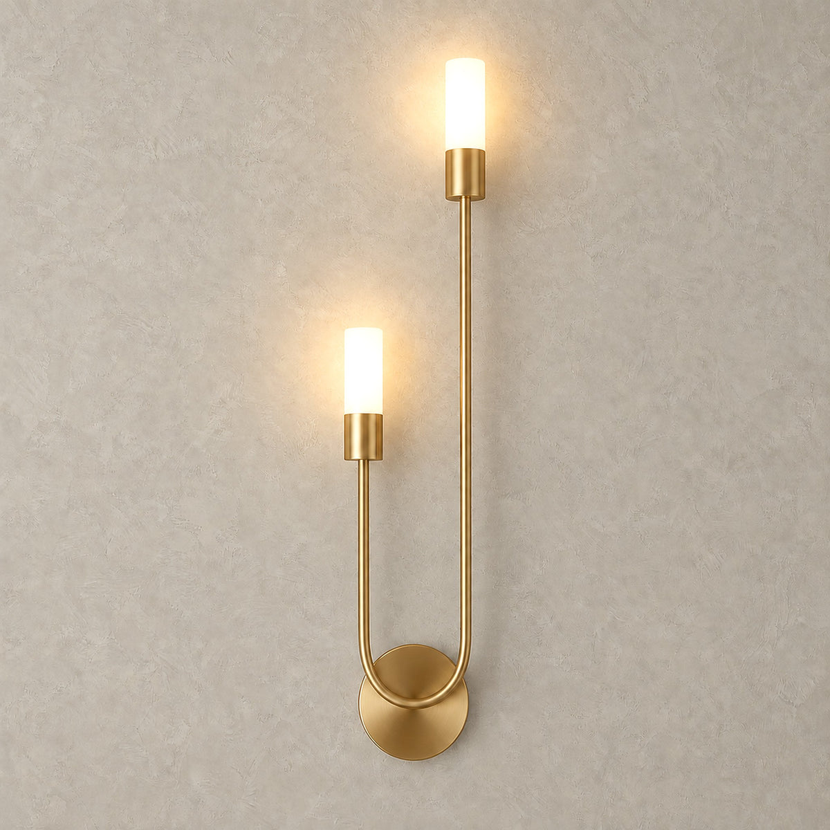 Amolven gold hardwired wall sconce with both heads lit against a plain backdrop