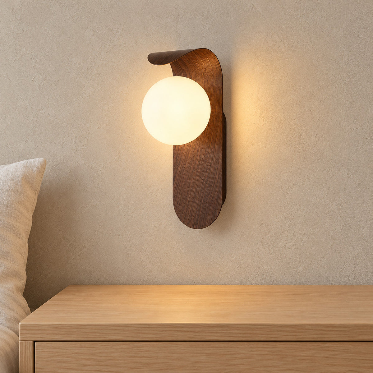 Arcelmo walnut bedside wall light glowing beside a pillow above an empty nightstand in a guest alcove