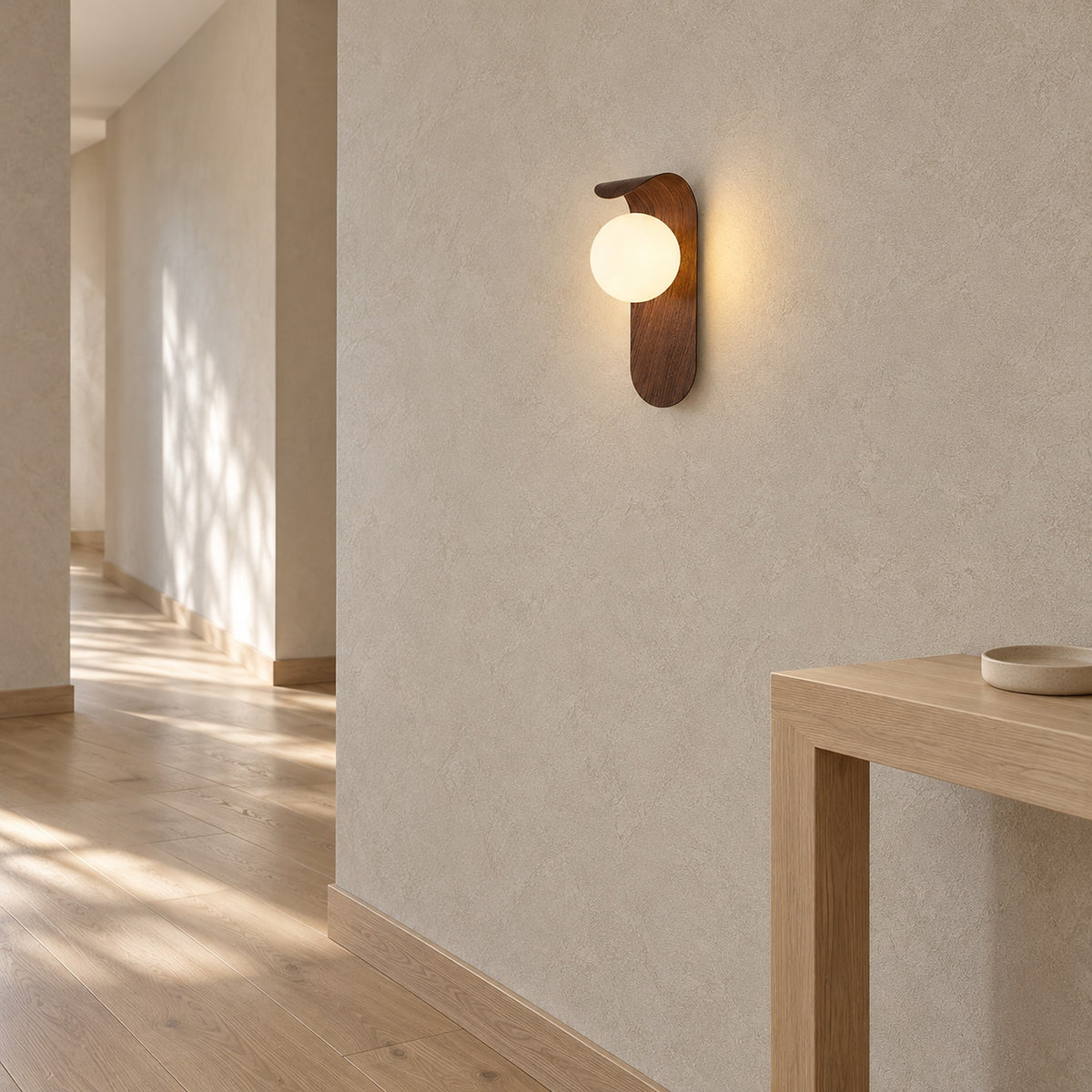 Arcelmo walnut hardwired wall light glowing on a hallway wall, connected to the house wiring at the wall
