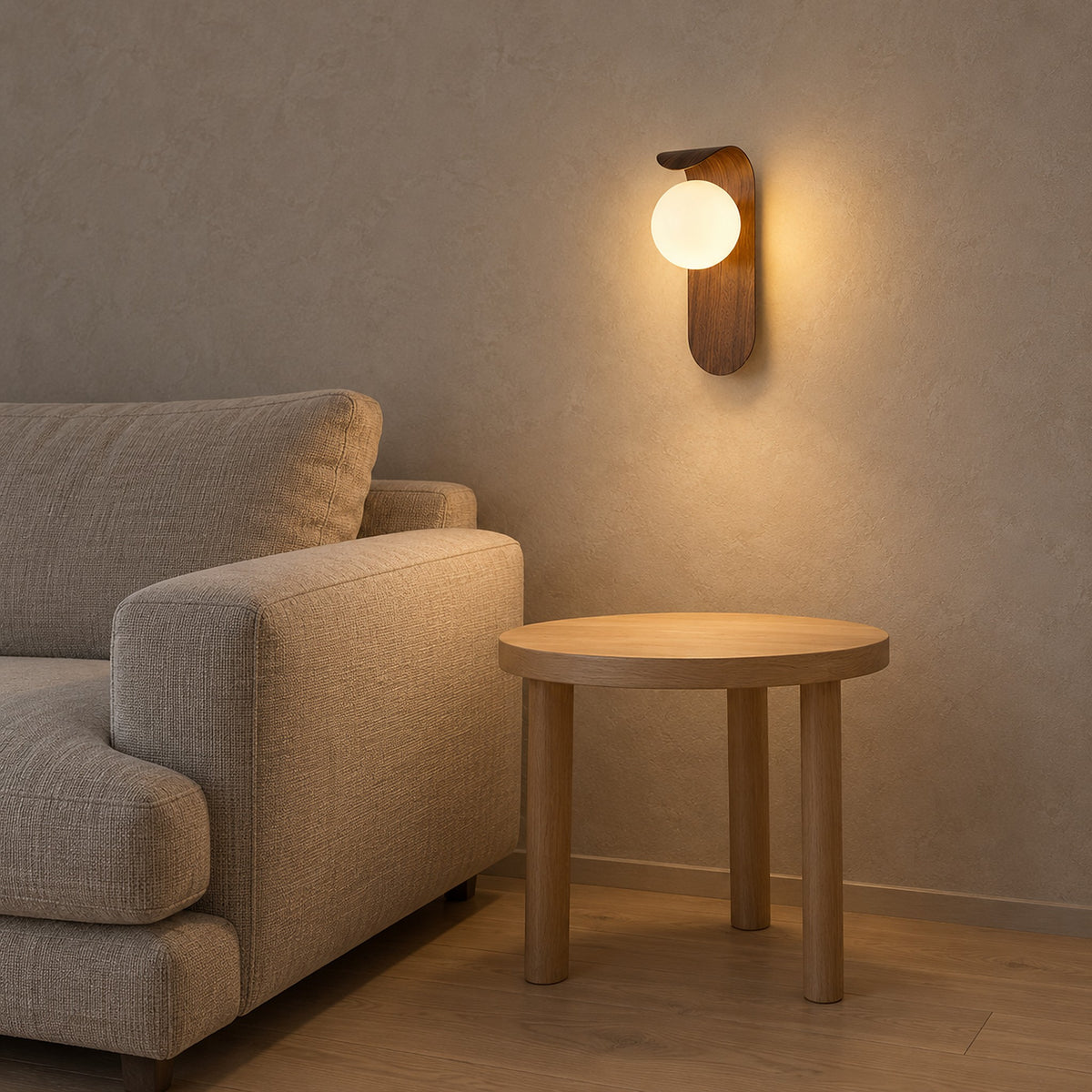 Arcelmo walnut wall light glowing above a bare end table in a living room