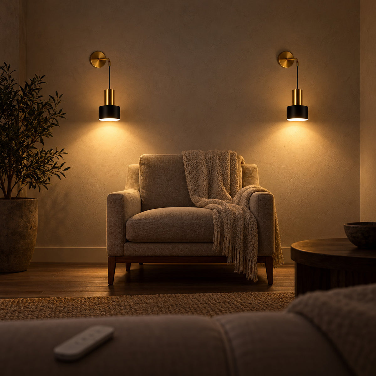 Arsomel black and gold wall light pair seen from the sofa in a living room at night