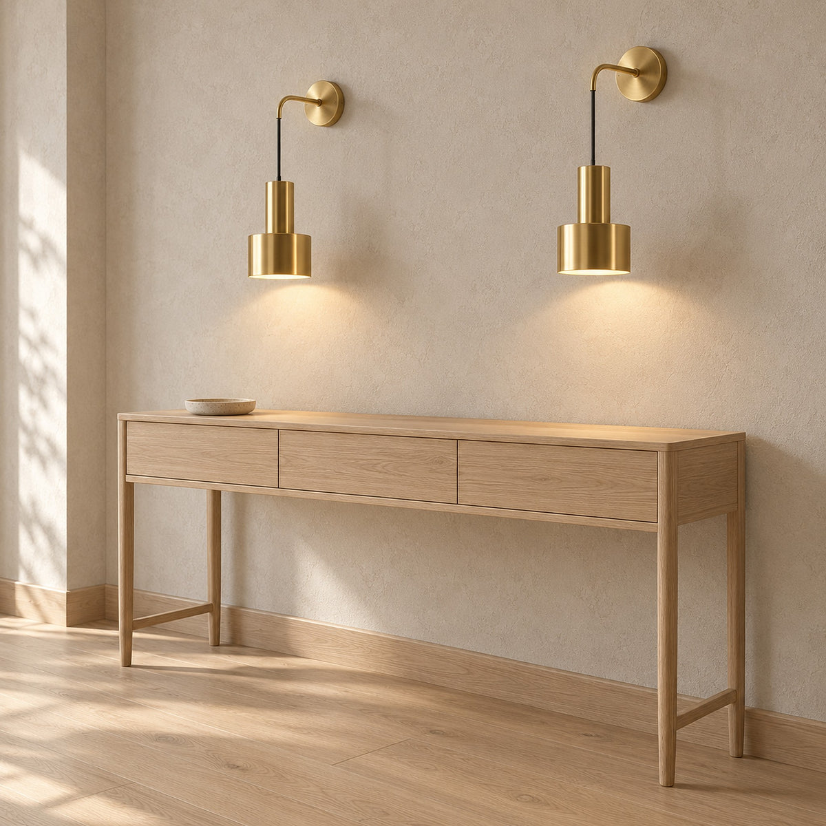 Arsomel gold wall lamp pair lit above a console table in a bright entryway nook #color_gold