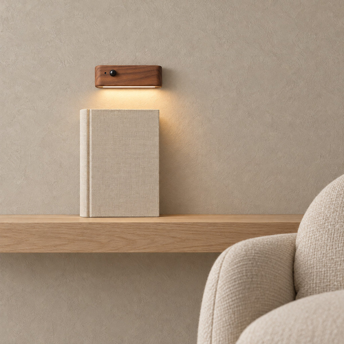 Calenvi walnut rechargeable motion sensor night light glowing above a pale shelf in a reading nook #color_walnut