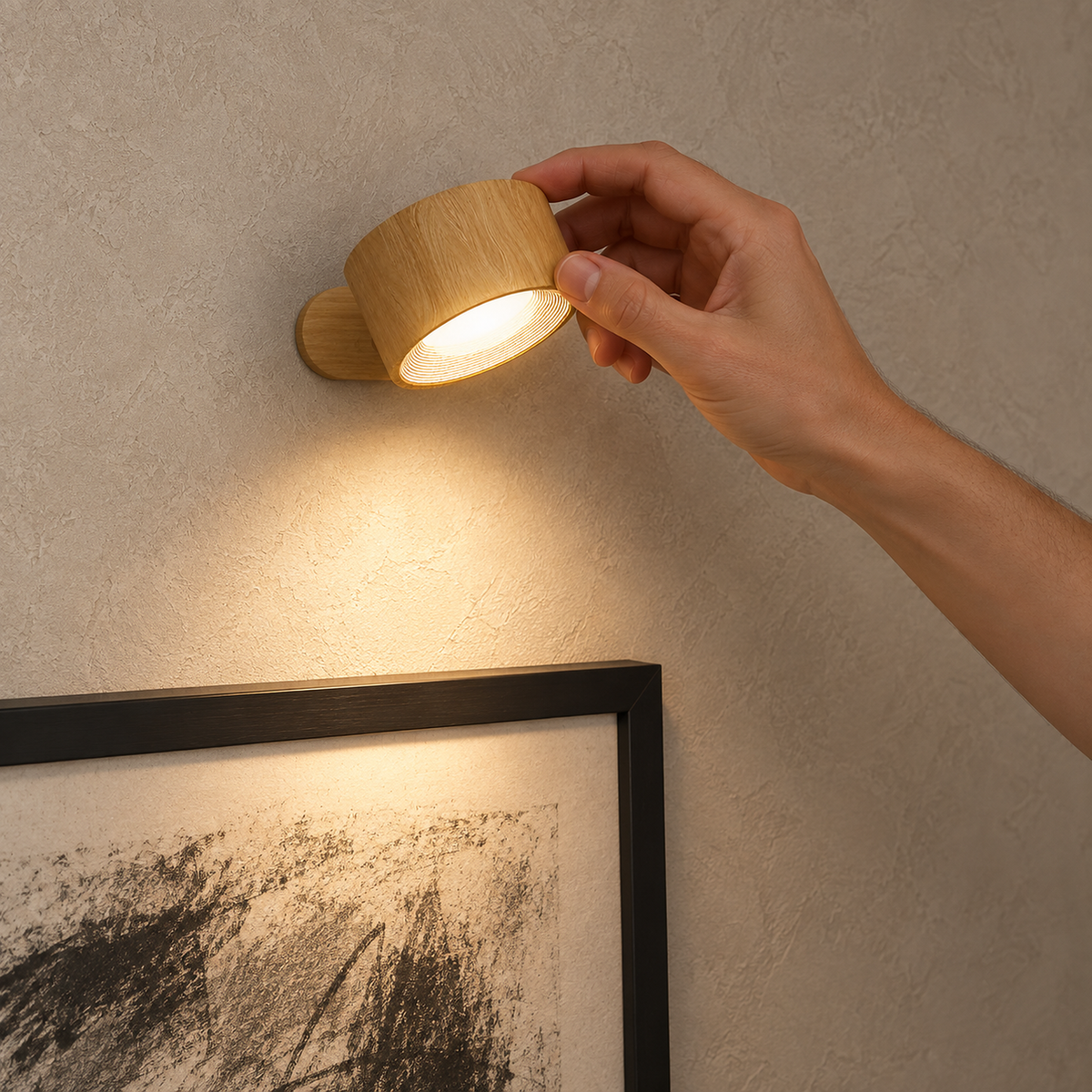 Caviloro LED wall sconce in wood effect angled to illuminate a drawing on hallway plaster