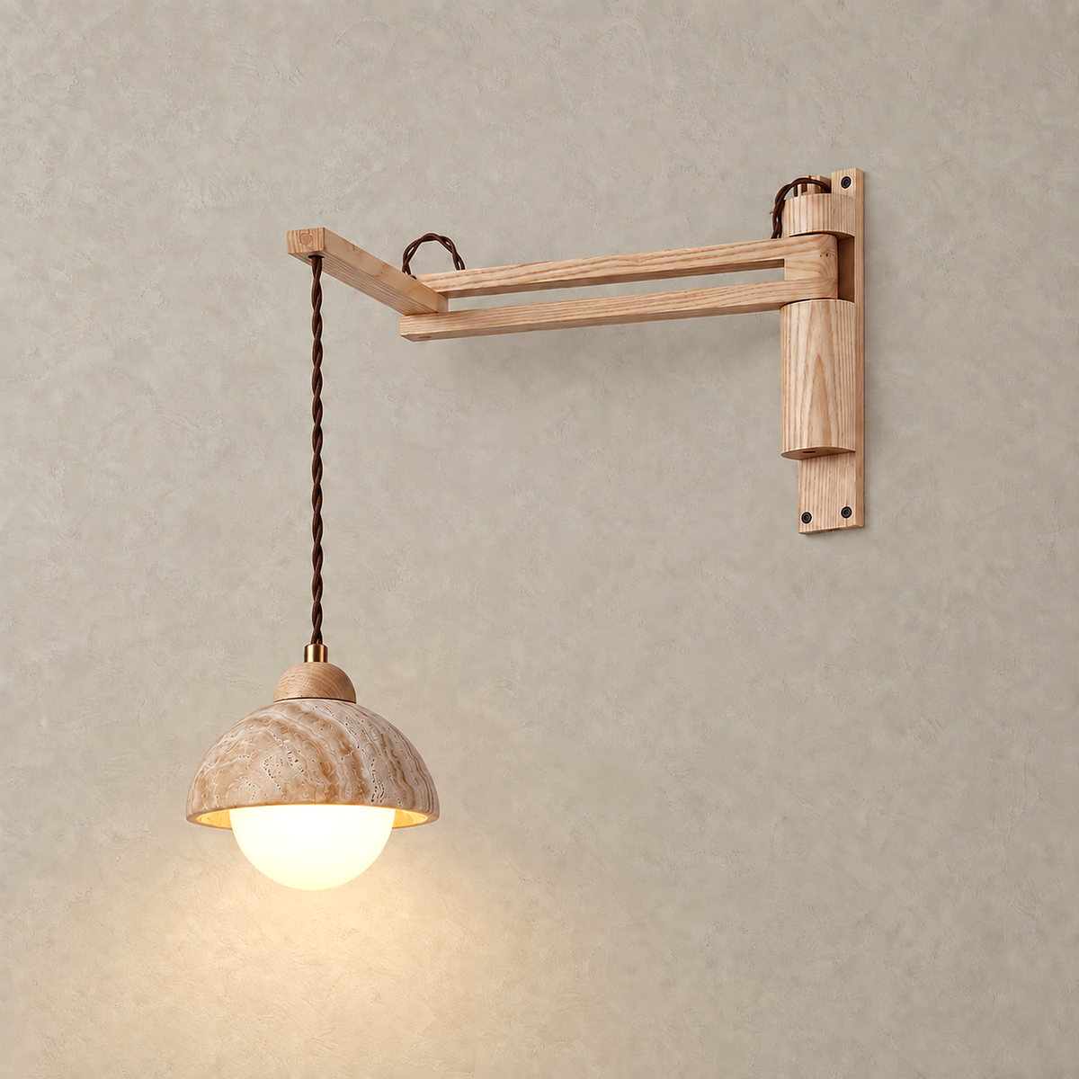 Cenaltro wood color travertine wall sconce glowing against a greige plaster wall when lit
