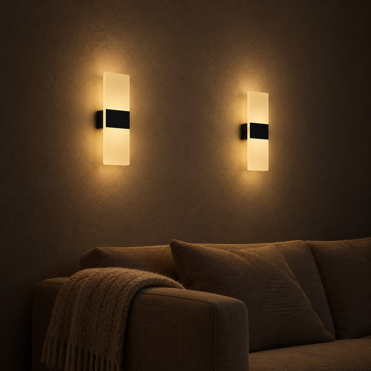 Ciloreva black battery operated wall sconce pair dimmed low beside a living room sofa