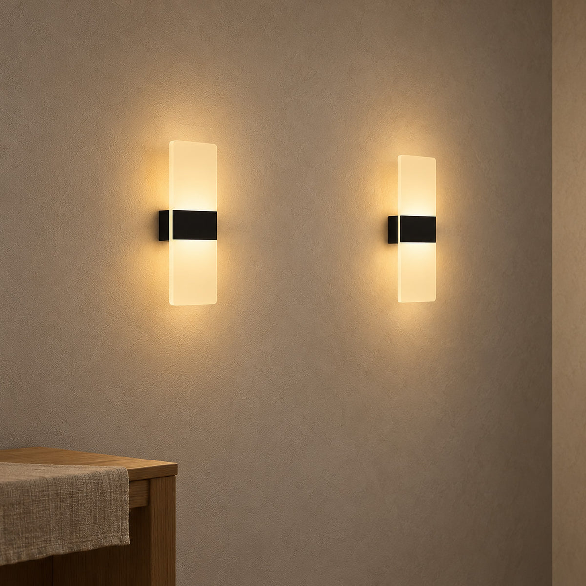 Ciloreva black wall light pair lit on bare hallway plaster in daylight
