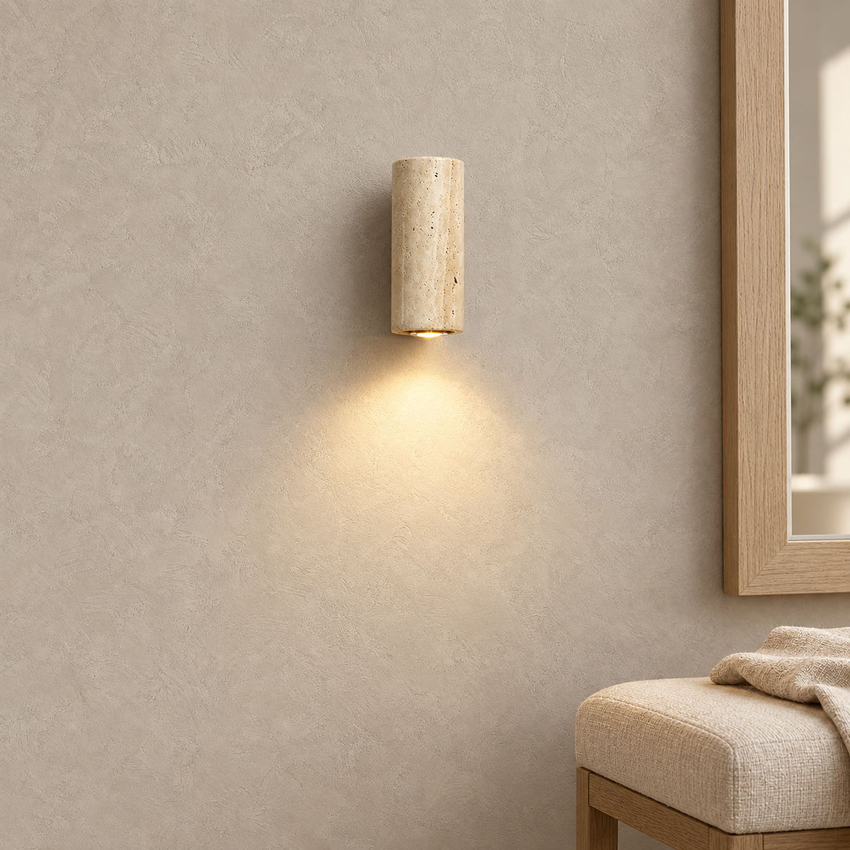 Cimorela slim travertine wall light glowing beside the edge of a dressing mirror