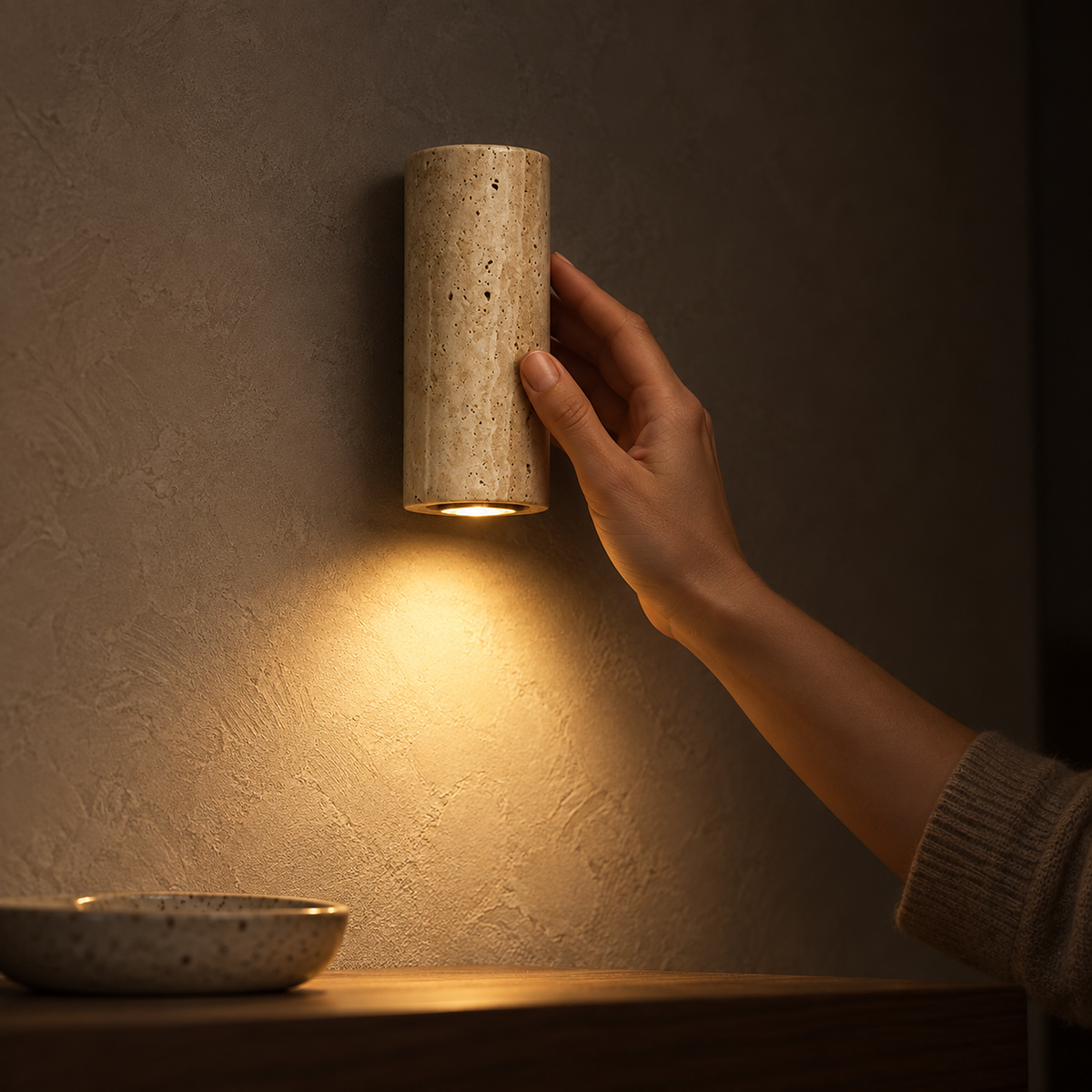 Cimorela wall sconce casting a small warm accent pool in an entryway at night