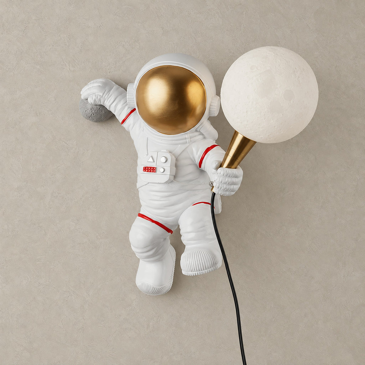 Ciremola white and gold plug in wall lamp, astronaut holding a globe shade, shown unlit