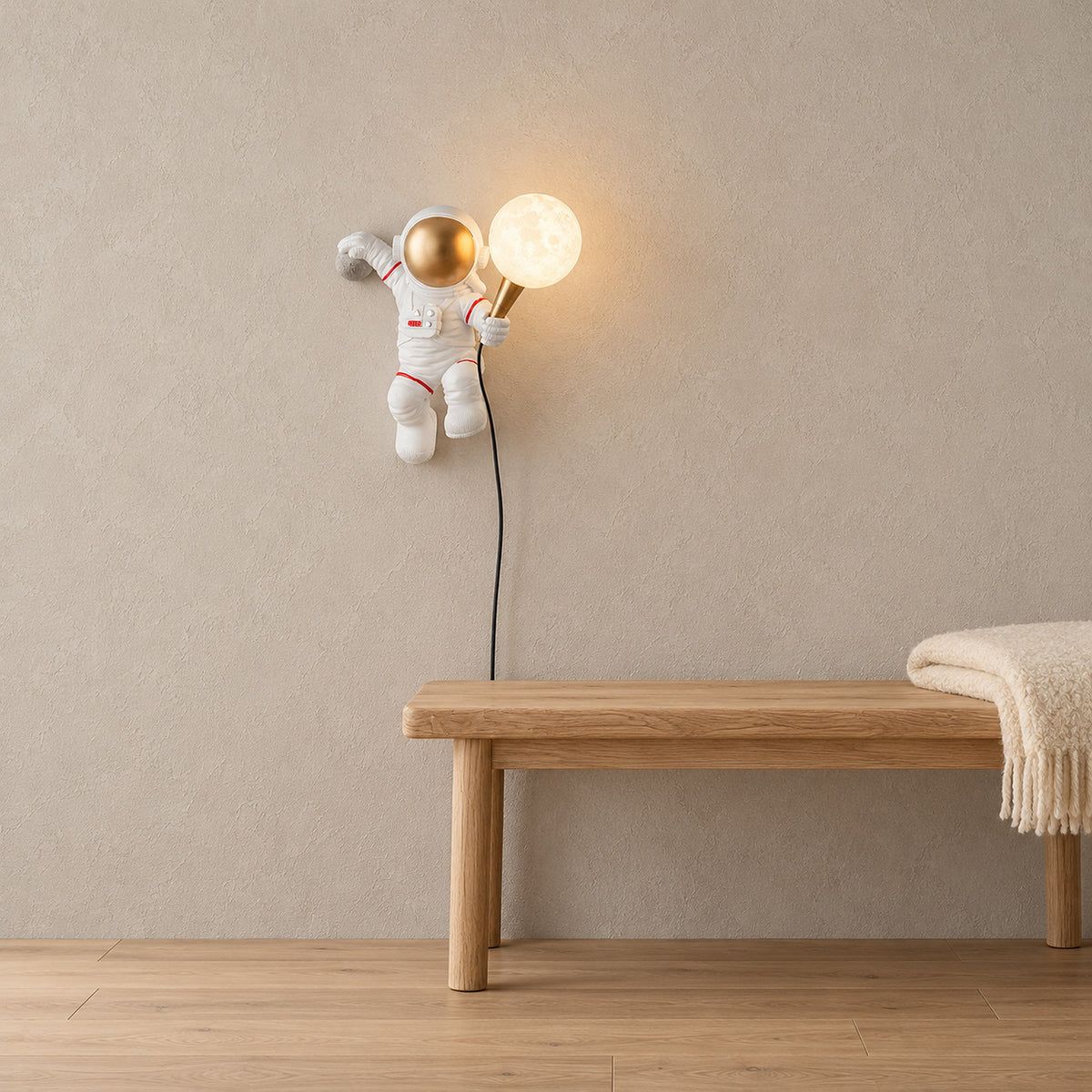 Ciremola white and gold plug in wall lamp in a hallway, cord running down to the outlet