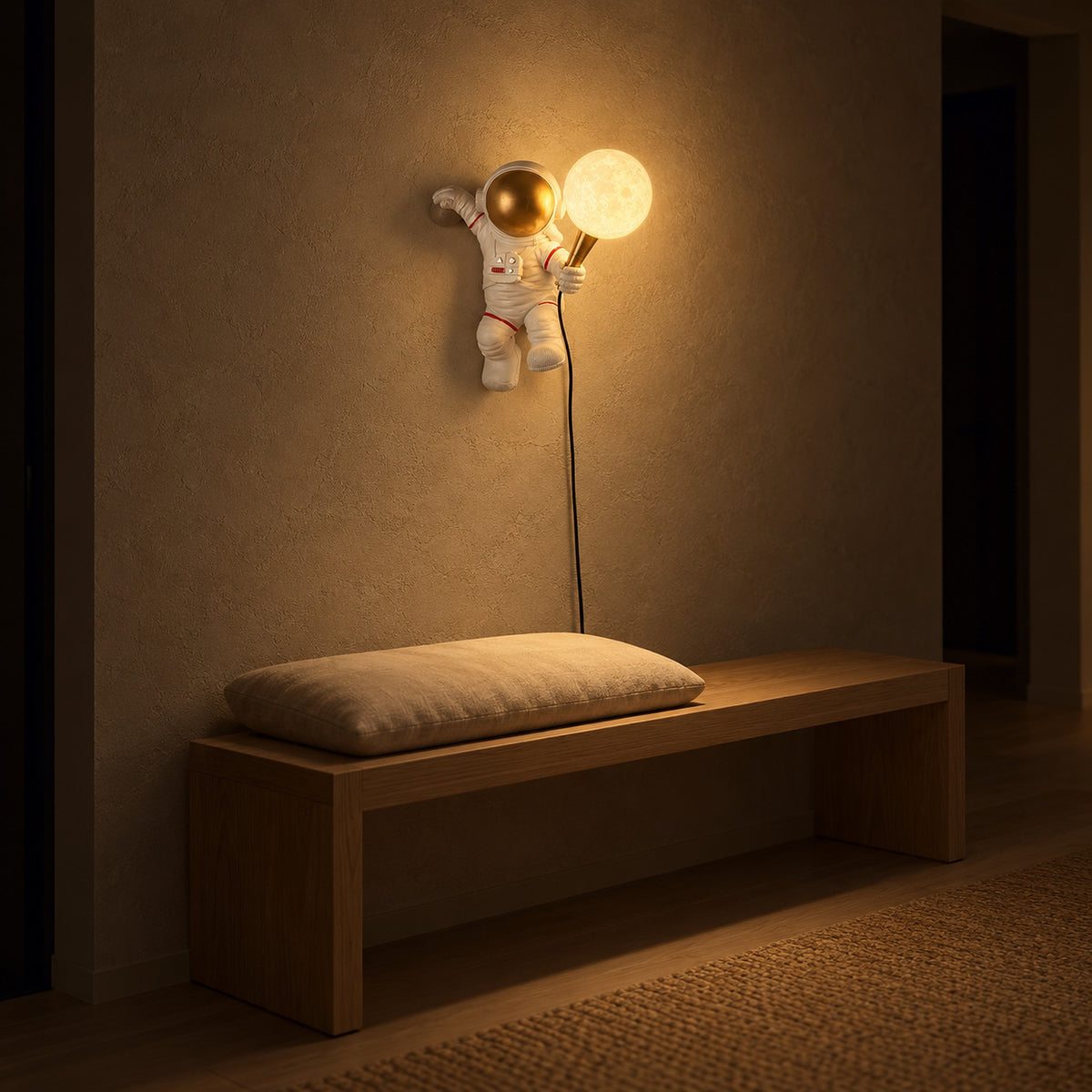 Ciremola white and gold plug in wall light glowing above an entry bench at night
