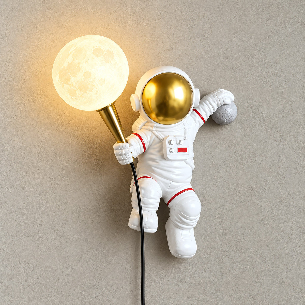 Ciremola white and gold plug in wall sconce, left version with the astronaut holding a glowing globe