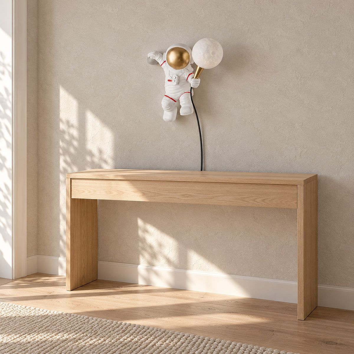 Ciremola white and gold plug in wall sconce, resin astronaut in sunlight on an entryway wall