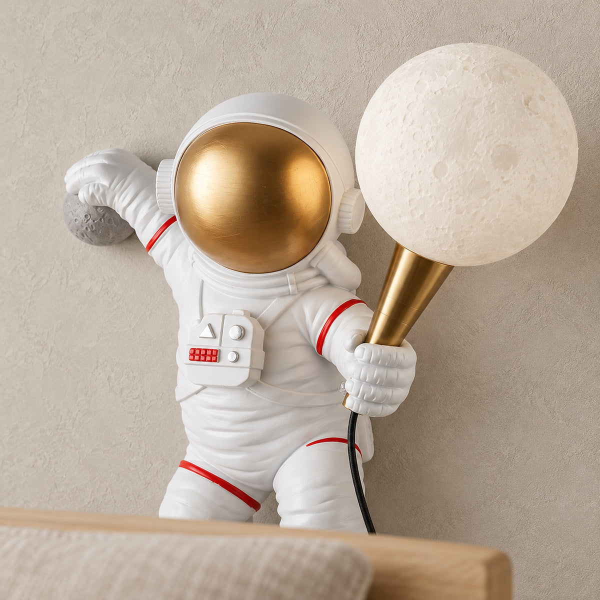 Ciremola white and gold wall lamp close up of the gold visor and globe support on the astronaut