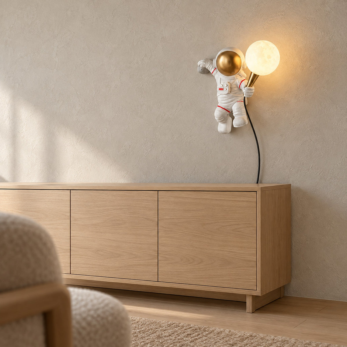 Ciremola white and gold wall lamp lit above a sideboard in a dining nook by day