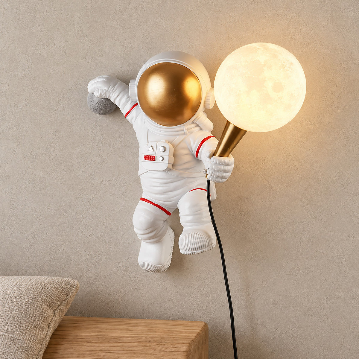 Ciremola white and gold wall sconce glowing above an entry bench, astronaut holding a lit globe