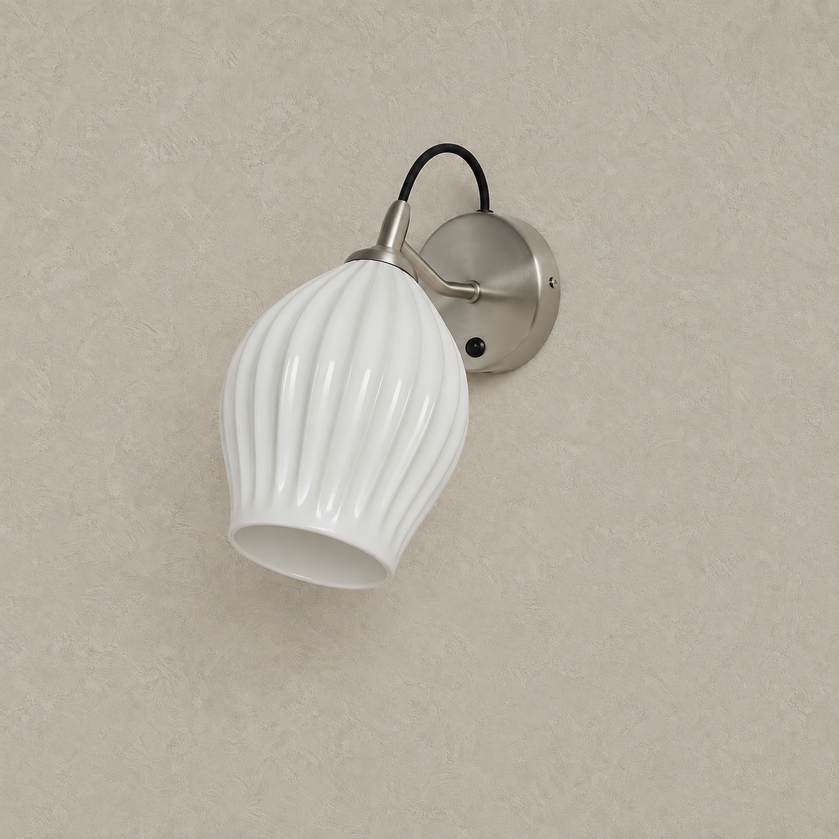 Comirel chrome LED wall sconce switched off against a greige plaster wall