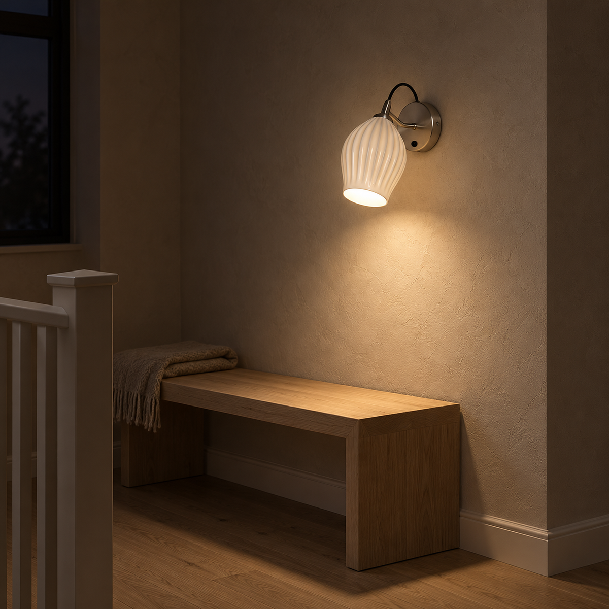 Comirel chrome wall light casting warm light onto a stair landing at night