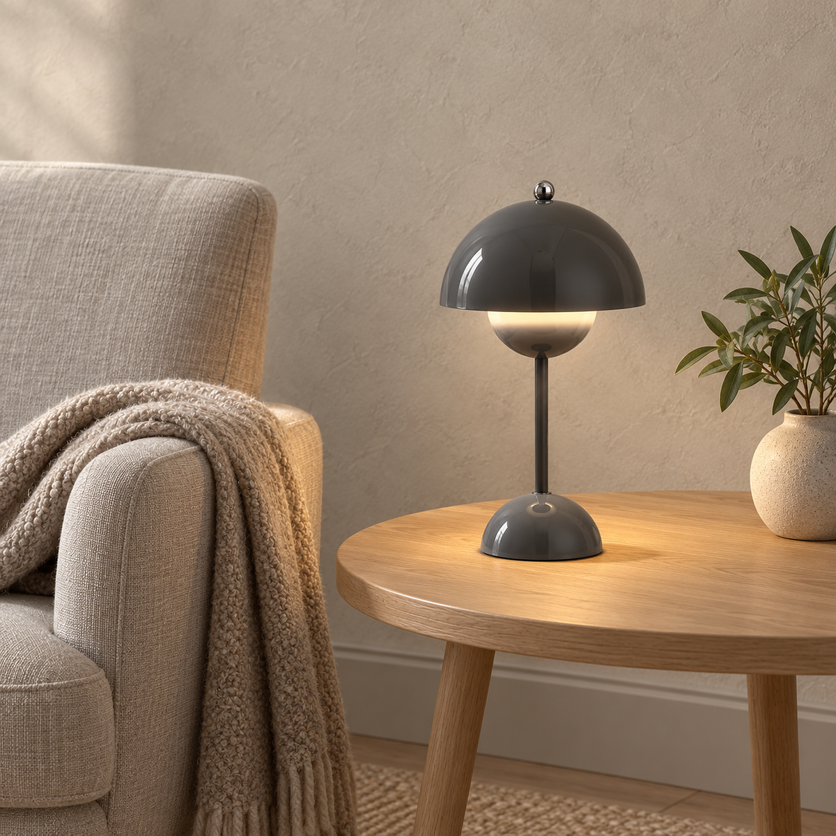 Coremila gray table lamp glowing beside an oatmeal library chair in daylight #color_gray