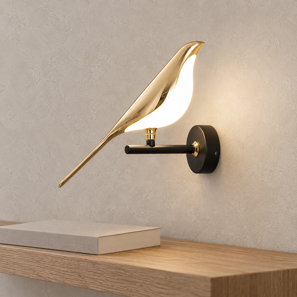 Corsavel 1 bird gold and black wall sconce with its lit acrylic underside beneath the reflective gold bird