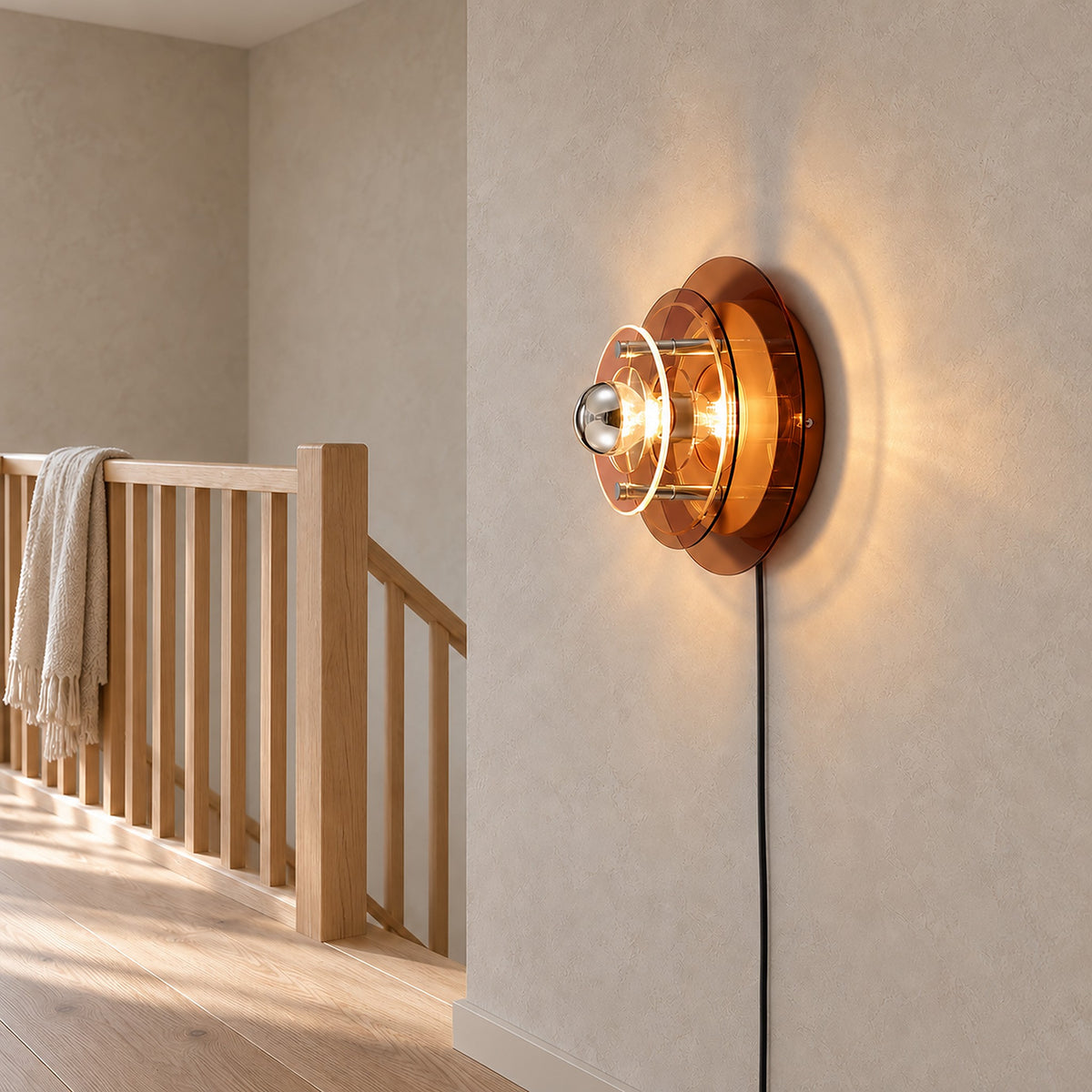 Elsarvo brown plug in wall sconce lit on a landing, side view of the stepped acrylic layers