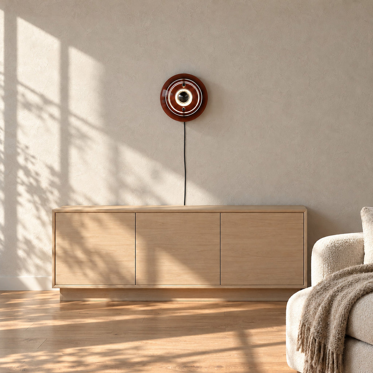 Elsarvo brown wall lamp unlit above a living room sideboard in daylight
