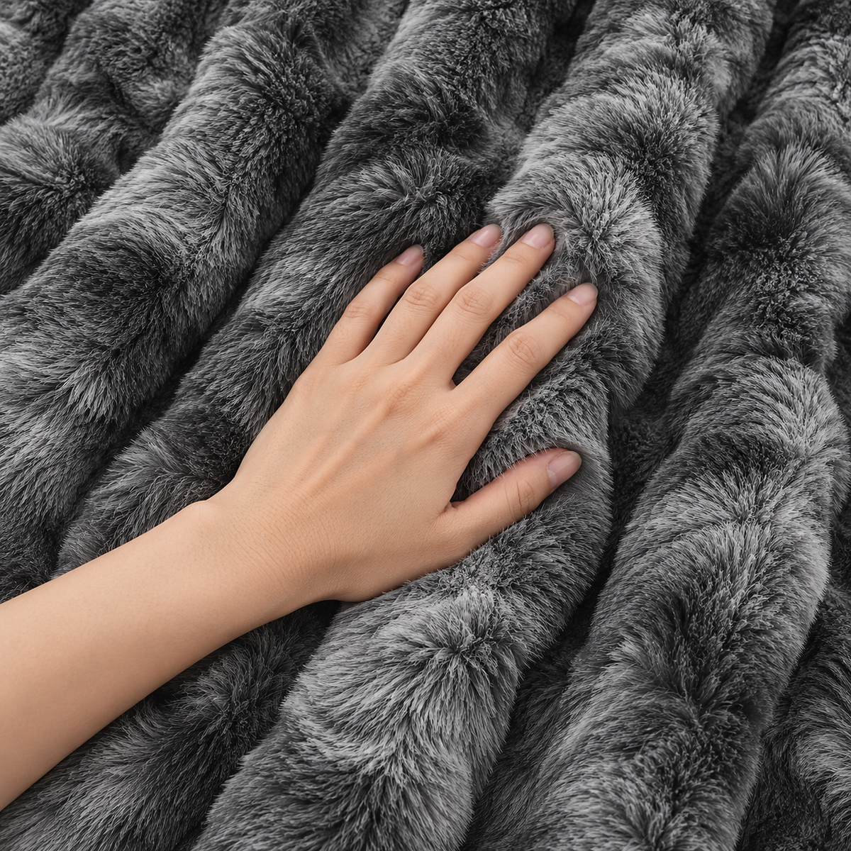 Elvasori gray throw blanket with a hand pressing into its plush rabbit fur look pile